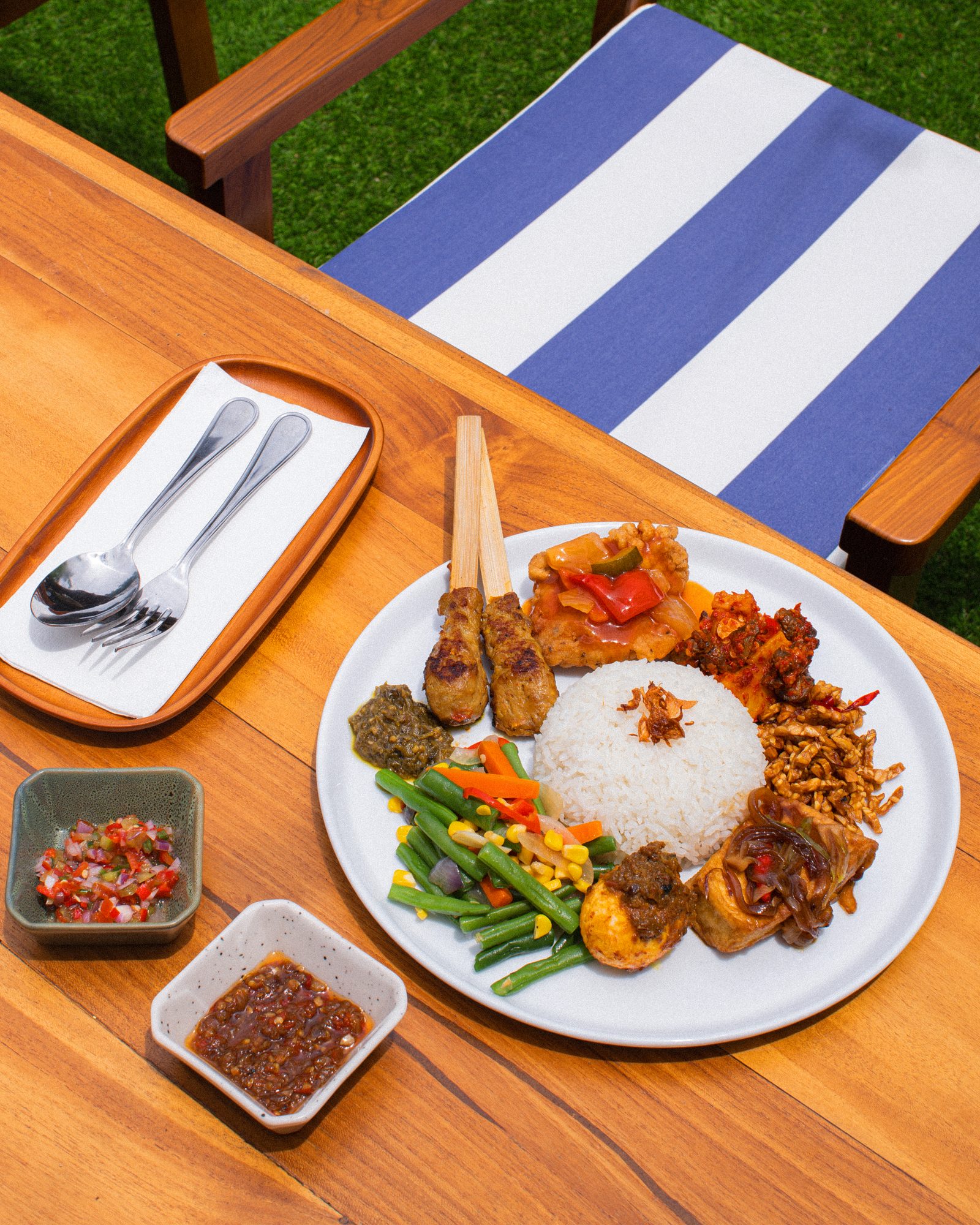 Table of Indonesian dishes at Mata Berawa on Jalan Berawa, Canggu